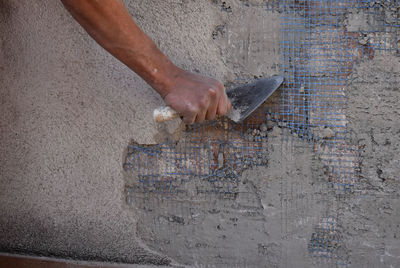 Hands of man working in masonry, unrecognisable