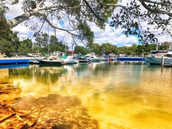 Boats moored in lake against sky