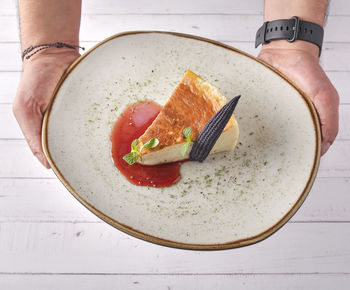 Cropped hand of woman holding food