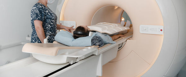 Midsection of radiologist scanning patient