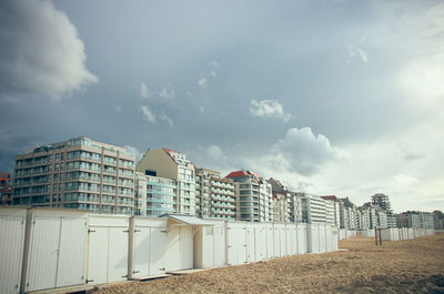 Low angle view of buildings against sky and beach in belgium