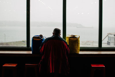 Rear view of man sitting in bus