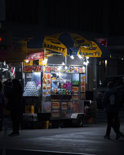 People walking on street at night