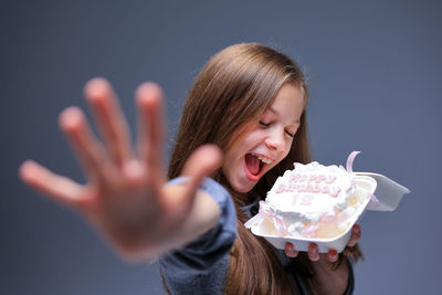 Portrait of young woman holding ice cream