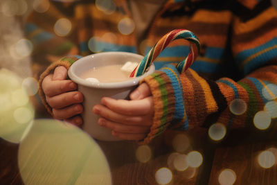 Close-up of hand holding coffee cup