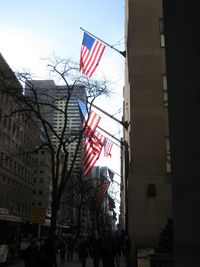 Low angle view of american flag against sky