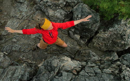 High angle view of woman exercising on rock formation