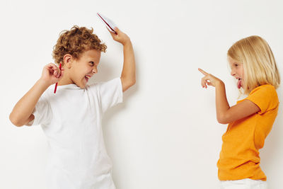 Sibling fighting against white background