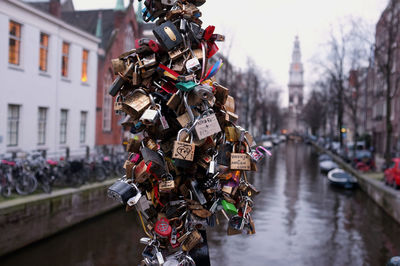 Bunch of padlocks on pole by canal