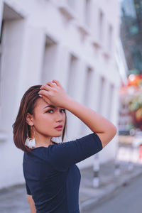 Portrait of a beautiful young woman in city