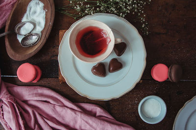 Directly above shot of herbal tea and macaroons on table