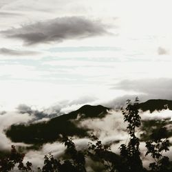 Scenic view of mountains against cloudy sky