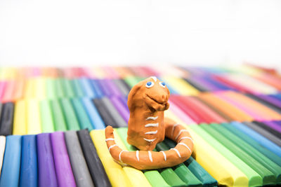 Close-up of colored pencils on table against white background