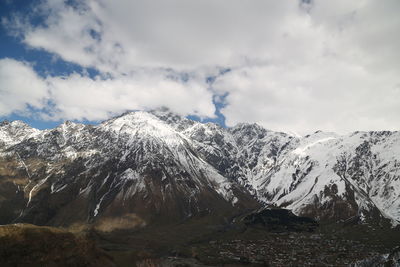 Scenic view of snowcapped mountains against sky