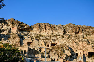 Low angle view of buildings against clear blue sky