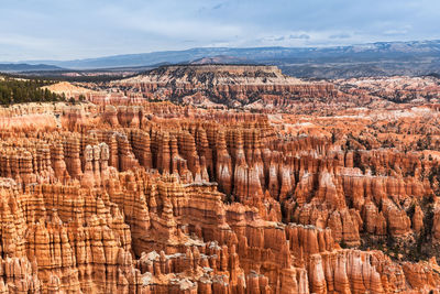 Aerial view of rock formations against cloudy sky