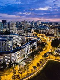 High angle view of illuminated street amidst buildings in city