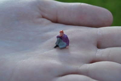 Low section of baby toy in hand