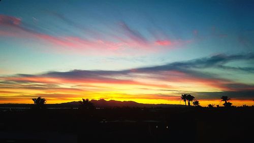 Silhouette landscape against sky during sunset