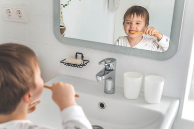 High angle view of mother and daughter in bathroom