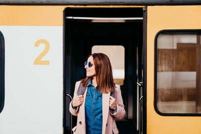 Full length of woman standing at train