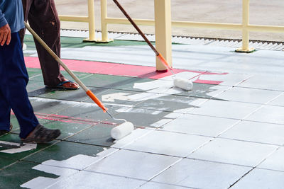 Low section of people working on footpath