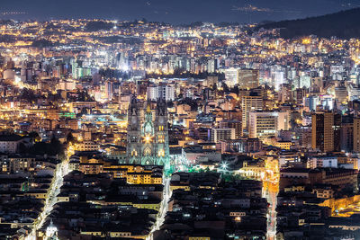 High angle view of city lit up at night