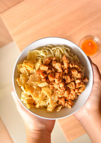 High angle view of person holding food in bowl