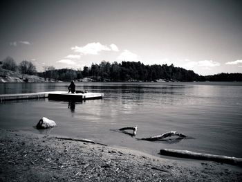 Calm lake with trees in background