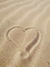 High angle view of heart shape on sand