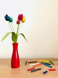 Close-up of multi colored vase on table against white background