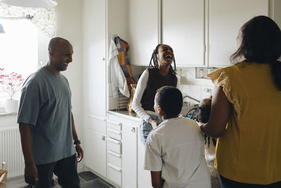 Cheerful family having fun in kitchen at home