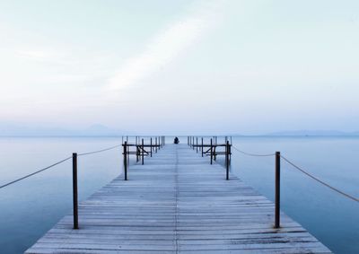 Pier over sea against clear sky