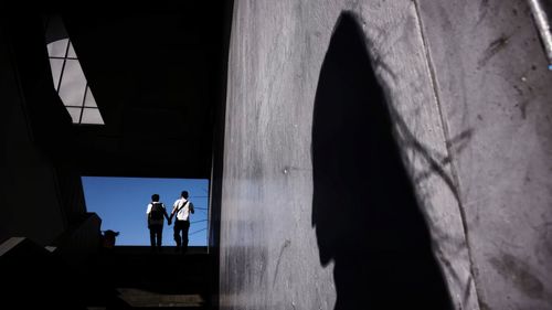 People standing in corridor of building