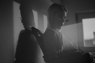 A young woman posing in studio during sunset