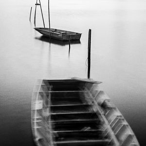 Sampans moored in calm lake