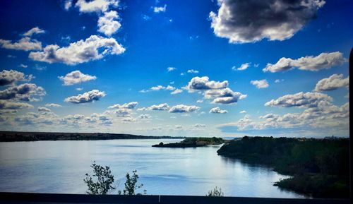 Scenic view of lake against cloudy sky