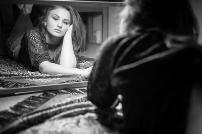 Young woman looking away while sitting in hair