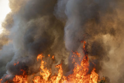 Low angle view of fire against clouds