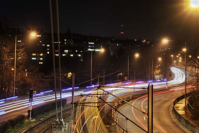 Light trails on railroad tracks at night