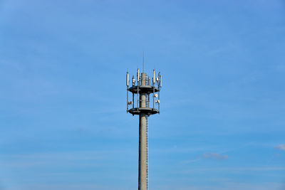 Low angle view of communications tower against sky