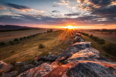 Scenic view of landscape against sky during sunset