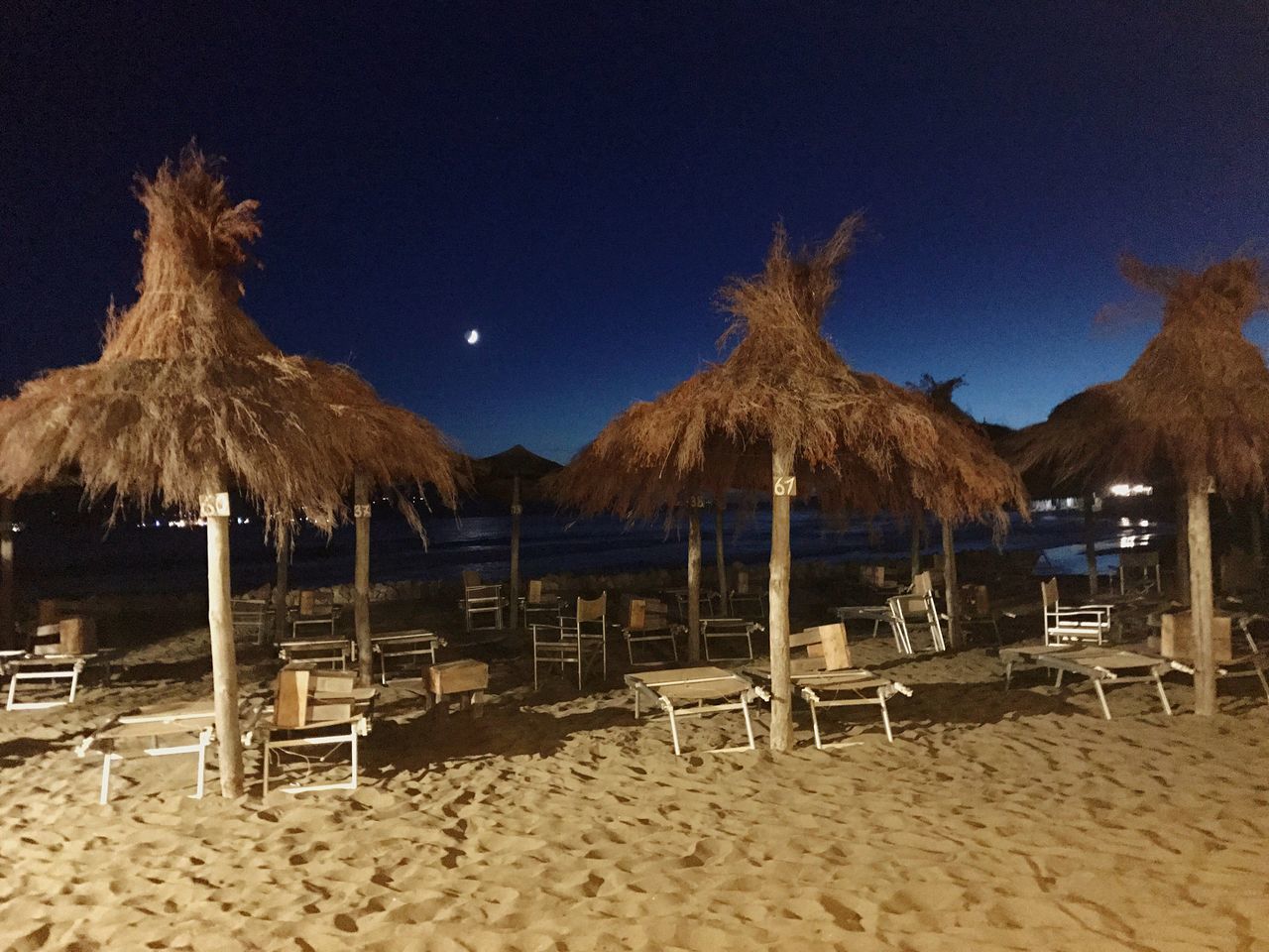 beach, sand, thatched roof, shore, vacations, sea, outdoors, nature, sun lounger, tranquil scene, tranquility, absence, canopy, summer, beauty in nature, relaxation, no people, day, scenics, water, sky