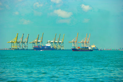 Commercial dock by sea against sky