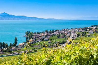 High angle view of sea and cityscape against sky