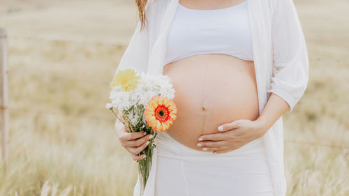 Young woman holding flower