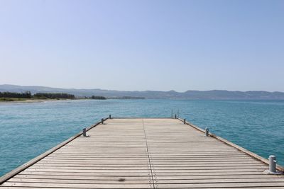 Pier over sea against clear sky