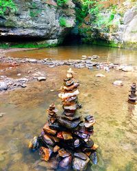 Statue amidst rocks in water