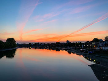 Scenic view of river against romantic sky at sunset