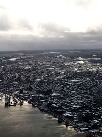 View of cityscape against cloudy sky